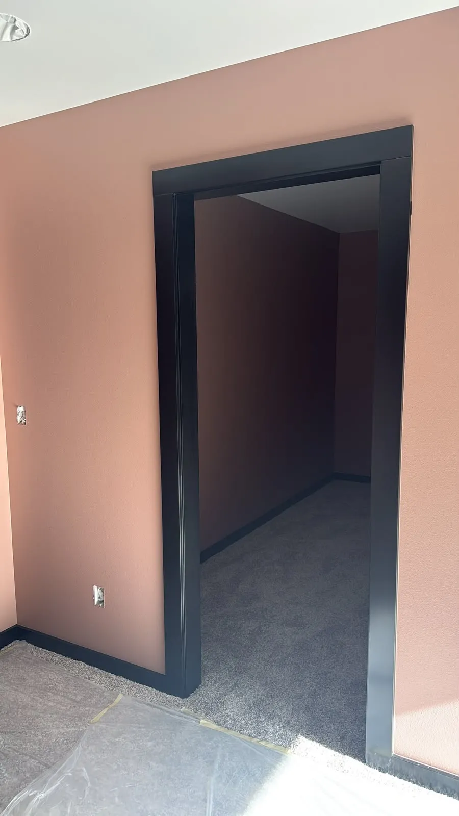 Clay-colored walls with a doorway trimmed in black